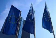 Bandeira da União Europeia e prédios corporativos